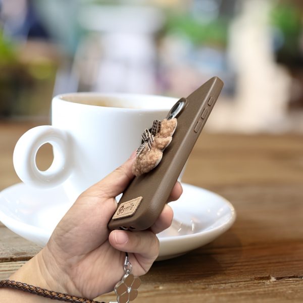 A Single-Pack Plush Teddy Bear Phone Case with a Bow, Available in White And Brown. It Comes with a Wrist Strap And Features a Simple And Elegant Faux Leather Texture That Is Anti-Slip And Fingerprint-Resistant. Made with TPU Full-Wrap Soft Rubber Technology, It Is Suitable for Apple Iphone Models Including XS, Xr, Xsmax, 11, Pro, Max, 12Pro, 13, Promax, 14, 14Pro, 14Promax, 15, 15Pro, 16, 16Pro, And 16Promax. - Image 13