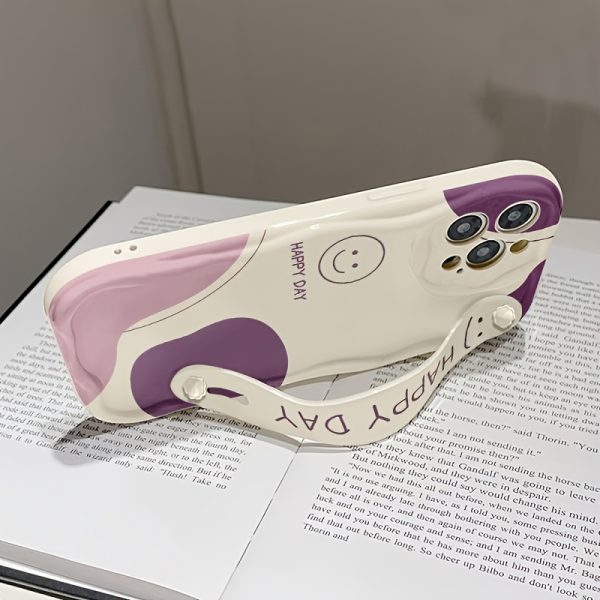 A White And Purple Dual-Tone Smiley Face Phone Case with a Cream Shell And Wrist Support, Featuring a Minimalist Design, Compatible with Models 16/16Plus/16Pro/16Promax/15/15Plus/15Promax/14/14Plus/14Pro/14Promax, 13/13Pro/13Promax, 12/12Pro/12Promax, 11/11Pro Max. - Image 4