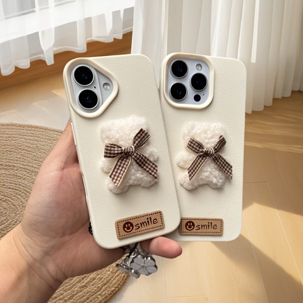 A Single-Pack Plush Teddy Bear Phone Case with a Bow, Available in White And Brown. It Comes with a Wrist Strap And Features a Simple And Elegant Faux Leather Texture That Is Anti-Slip And Fingerprint-Resistant. Made with TPU Full-Wrap Soft Rubber Technology, It Is Suitable for Apple Iphone Models Including XS, Xr, Xsmax, 11, Pro, Max, 12Pro, 13, Promax, 14, 14Pro, 14Promax, 15, 15Pro, 16, 16Pro, And 16Promax. - Image 6