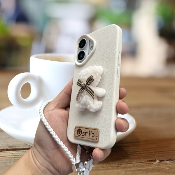 A Single-Pack Plush Teddy Bear Phone Case with a Bow, Available in White And Brown. It Comes with a Wrist Strap And Features a Simple And Elegant Faux Leather Texture That Is Anti-Slip And Fingerprint-Resistant. Made with TPU Full-Wrap Soft Rubber Technology, It Is Suitable for Apple Iphone Models Including XS, Xr, Xsmax, 11, Pro, Max, 12Pro, 13, Promax, 14, 14Pro, 14Promax, 15, 15Pro, 16, 16Pro, And 16Promax. - Image 10