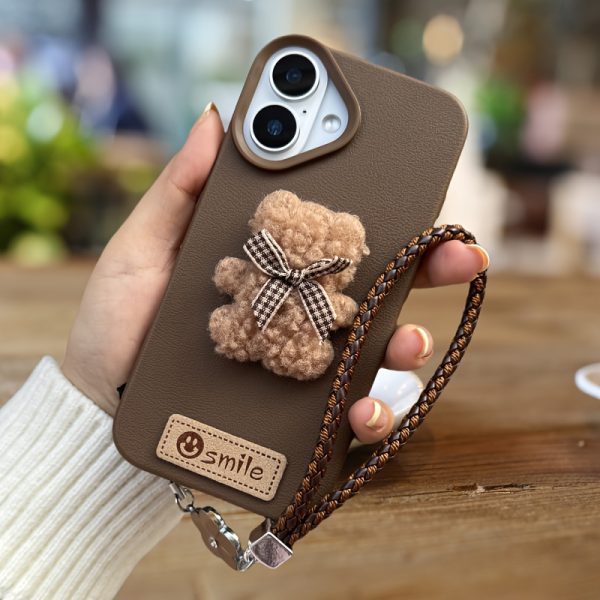 A Single-Pack Plush Teddy Bear Phone Case with a Bow, Available in White And Brown. It Comes with a Wrist Strap And Features a Simple And Elegant Faux Leather Texture That Is Anti-Slip And Fingerprint-Resistant. Made with TPU Full-Wrap Soft Rubber Technology, It Is Suitable for Apple Iphone Models Including XS, Xr, Xsmax, 11, Pro, Max, 12Pro, 13, Promax, 14, 14Pro, 14Promax, 15, 15Pro, 16, 16Pro, And 16Promax. - Image 9