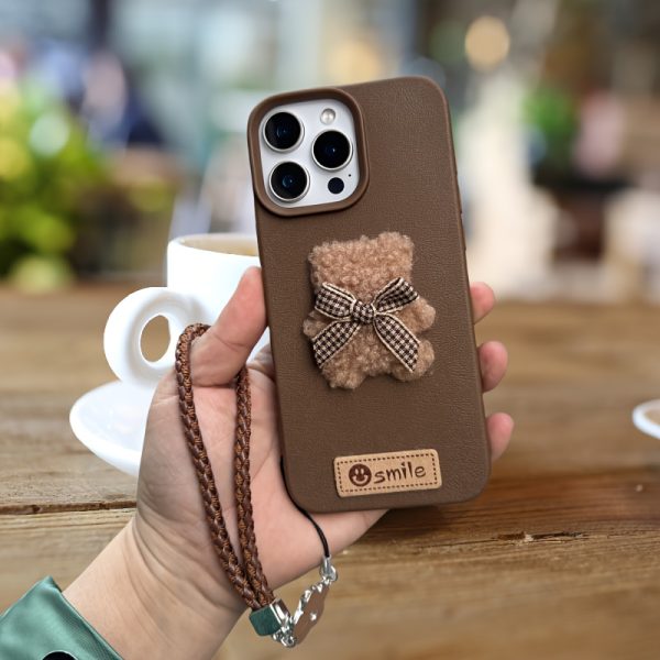 A Single-Pack Plush Teddy Bear Phone Case with a Bow, Available in White And Brown. It Comes with a Wrist Strap And Features a Simple And Elegant Faux Leather Texture That Is Anti-Slip And Fingerprint-Resistant. Made with TPU Full-Wrap Soft Rubber Technology, It Is Suitable for Apple Iphone Models Including XS, Xr, Xsmax, 11, Pro, Max, 12Pro, 13, Promax, 14, 14Pro, 14Promax, 15, 15Pro, 16, 16Pro, And 16Promax. - Image 11
