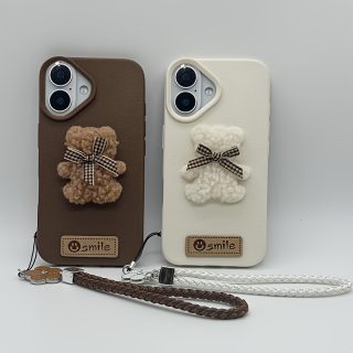 A Single-Pack Plush Teddy Bear Phone Case with a Bow, Available in White And Brown. It Comes with a Wrist Strap And Features a Simple And Elegant Faux Leather Texture That Is Anti-Slip And Fingerprint-Resistant. Made with TPU Full-Wrap Soft Rubber Technology, It Is Suitable for Apple Iphone Models Including XS, Xr, Xsmax, 11, Pro, Max, 12Pro, 13, Promax, 14, 14Pro, 14Promax, 15, 15Pro, 16, 16Pro, And 16Promax.