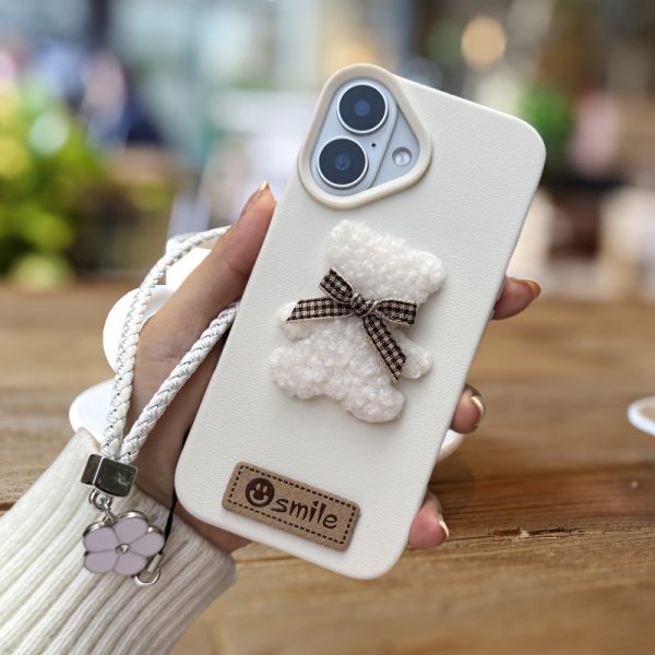 A Single-Pack Plush Teddy Bear Phone Case with a Bow, Available in White And Brown. It Comes with a Wrist Strap And Features a Simple And Elegant Faux Leather Texture That Is Anti-Slip And Fingerprint-Resistant. Made with TPU Full-Wrap Soft Rubber Technology, It Is Suitable for Apple Iphone Models Including XS, Xr, Xsmax, 11, Pro, Max, 12Pro, 13, Promax, 14, 14Pro, 14Promax, 15, 15Pro, 16, 16Pro, And 16Promax. - Image 7