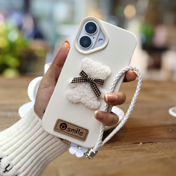 A Single-Pack Plush Teddy Bear Phone Case with a Bow, Available in White And Brown. It Comes with a Wrist Strap And Features a Simple And Elegant Faux Leather Texture That Is Anti-Slip And Fingerprint-Resistant. Made with TPU Full-Wrap Soft Rubber Technology, It Is Suitable for Apple Iphone Models Including XS, Xr, Xsmax, 11, Pro, Max, 12Pro, 13, Promax, 14, 14Pro, 14Promax, 15, 15Pro, 16, 16Pro, And 16Promax. - Image 4